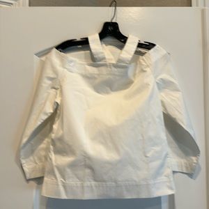 Nomia off the shoulder with straps that hold up the top part of the blouse.